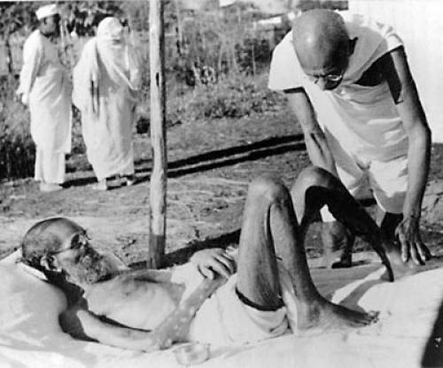 Gandhiji giving massage,to a leper patient, the Sanskrit scholar Parchure Shastri, at Sevagram Ashram in 1940. Source: Wikimedia Commons
