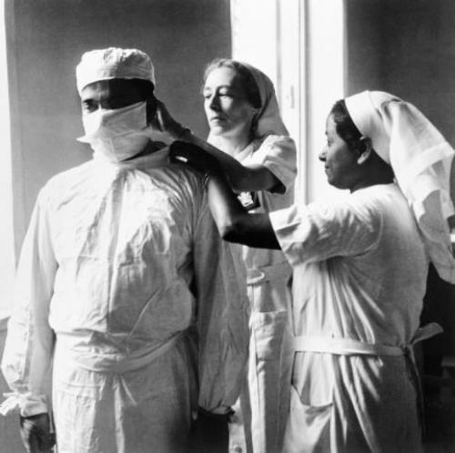 Noble profession: Nurses adjusting a doctor's mask in Calcutta during World War II. Source: Cecil Beaton/Wikicommons