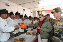Indian soldiers breaking bread with PM Modi at Siachen. Every day a helicopter drops canned food here. Source: PIB
